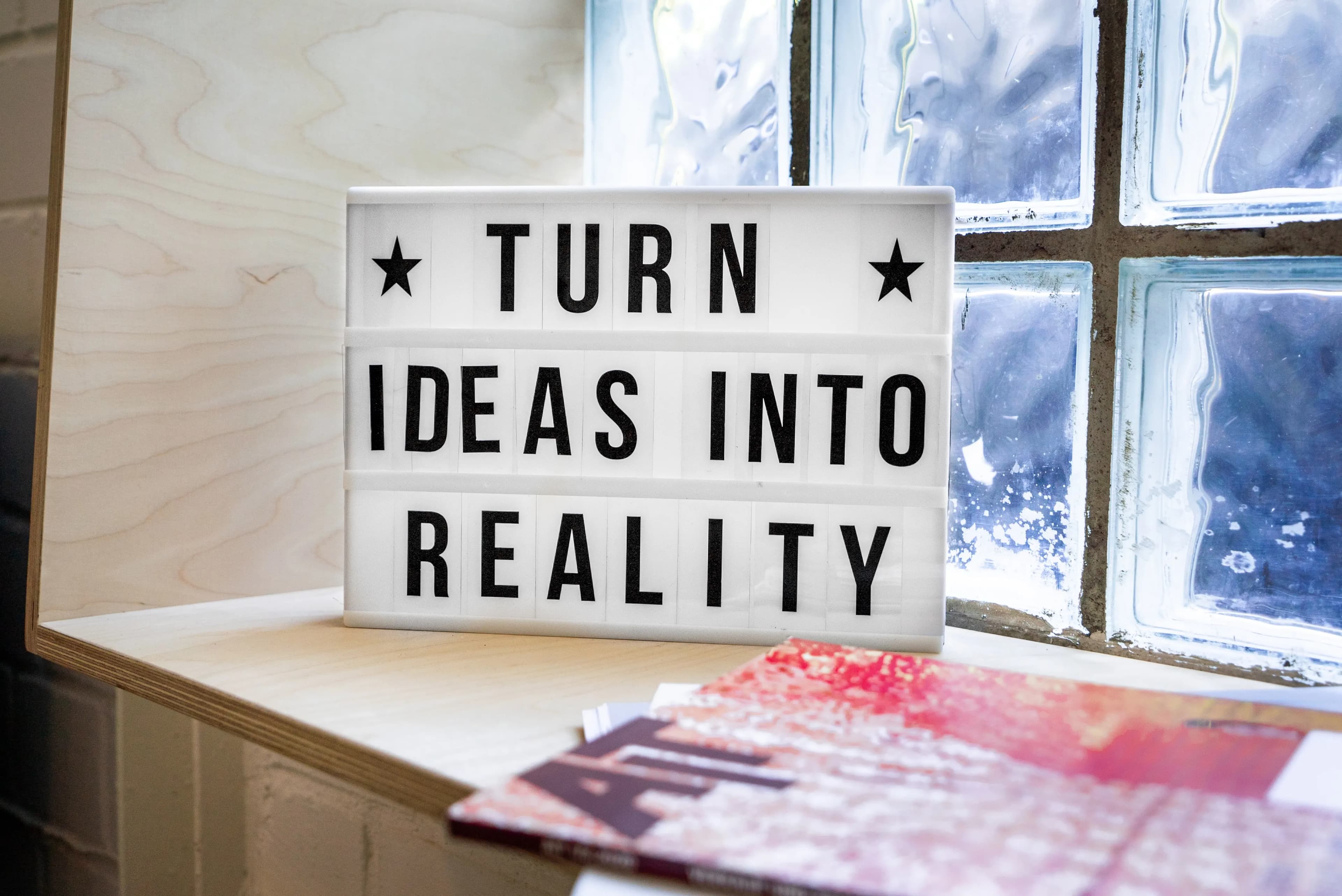 A stock photo by Mika Baumeister of a sign saying 'Turn ideas into reality'